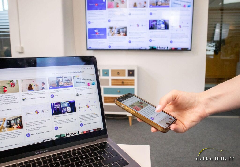 Person using smartphone and laptop with social media content on screen