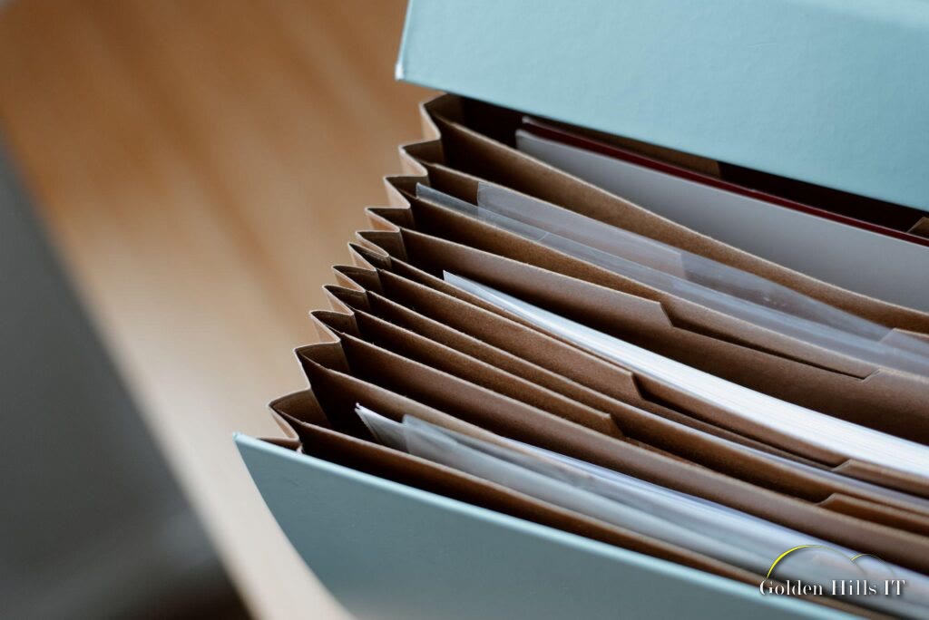 Organized file folders in a box labeled Golden Hills IT