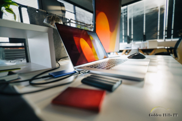 Modern office desk with laptop and external drives